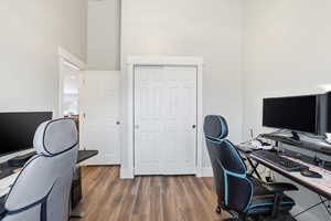 Office with dark wood finished floors and a high ceiling