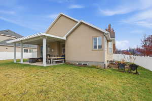 Rear view of property featuring a fenced backyard, a patio, and stucco siding