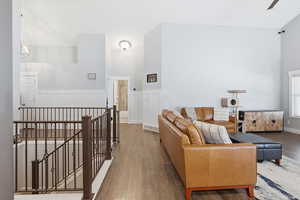 Living room featuring wainscoting, wood finished floors, and a decorative wall
