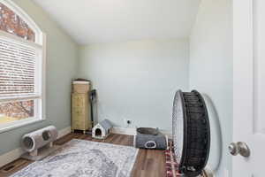 Misc room featuring dark wood-style floors and baseboards