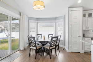 Dining room featuring plenty of natural light and dark wood finished floors