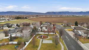 Aerial overview of property's location with nearby suburban area and mountains