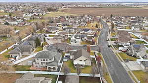 Aerial view of property and surrounding area featuring nearby suburban area