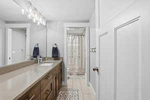 Bathroom featuring vanity and light tile patterned flooring