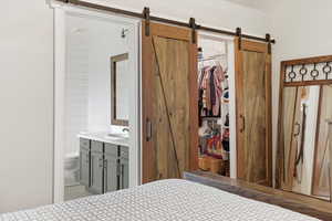 Bedroom with a walk in closet and connected bathroom