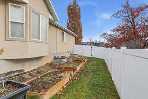 Fenced backyard with a vegetable garden