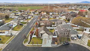 Aerial overview of property's location with nearby suburban area and mountains