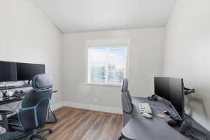 Office space featuring dark wood-style flooring and baseboards
