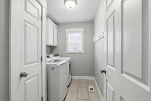Washroom with separate washer and dryer and cabinet space