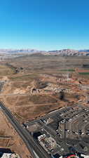 Aerial view of property and surrounding area featuring a mountainous background and rural landscape
