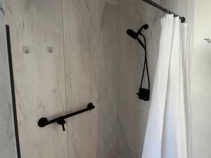 Bathroom view of a marble finish shower