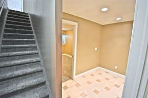 Stairs featuring recessed lighting and baseboards