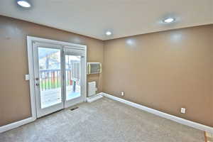 Carpeted spare room featuring baseboards and recessed lighting