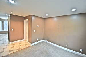 Spare room with carpet floors and recessed lighting
