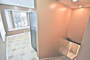 Detailed view of recessed lighting and baseboards