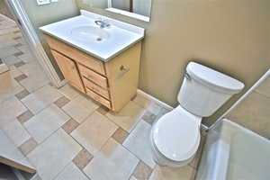 Full bathroom featuring vanity and light tile patterned flooring