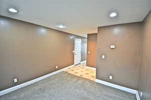 Spare room with light carpet and recessed lighting