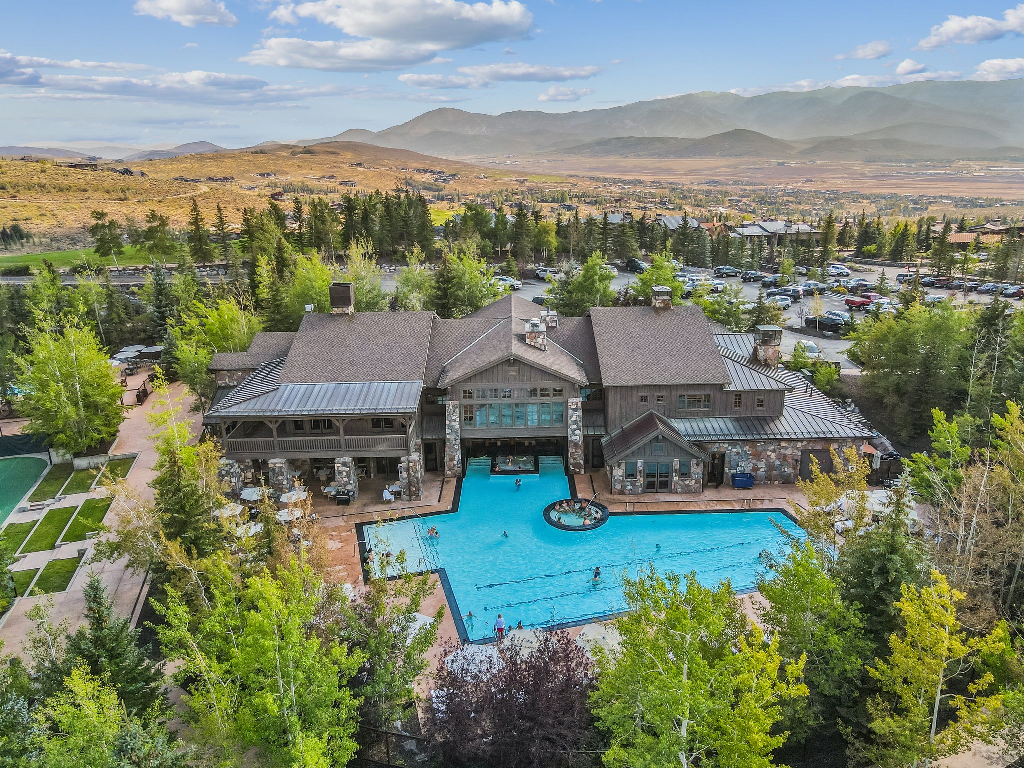 Community pool featuring a patio, a mountain view, and a balcony