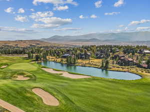View of property's community with a water and mountain view, view of golf course, and a residential view