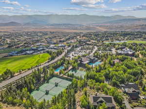 Aerial perspective of suburban area featuring mountains and a golf course