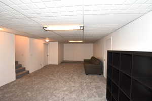 Unfurnished room featuring carpet floors and stairway