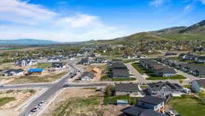 Aerial view of property's location featuring mountains and nearby suburban area