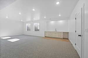 Basement featuring light colored carpet and recessed lighting