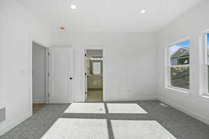Unfurnished bedroom featuring carpet flooring, ensuite bathroom, and recessed lighting