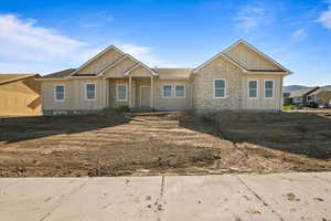 View of front facade with board and batten siding and stone siding