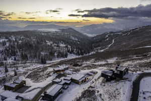 Snowy aerial view featuring a mountain view