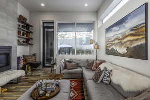 Living area with a fireplace and wood finished floors