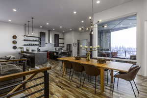 Dining area featuring a chandelier, wood finished floors, and recessed lighting