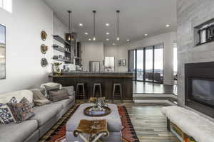 Living area with wood finished floors, recessed lighting, and a fireplace