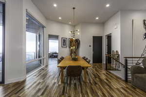 Dining room featuring recessed lighting, wood-type flooring, and a chandelier