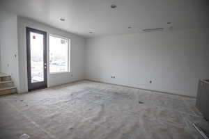 Empty room with baseboards and stairs