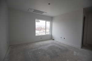 Empty room featuring baseboards and cooling unit