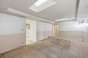 Carpeted empty room featuring a textured ceiling