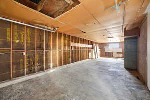 Miscellaneous room featuring concrete floors and concrete block wall