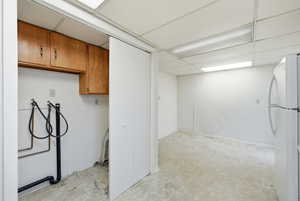 Laundry room featuring cabinet space, a paneled ceiling, and washer hookup