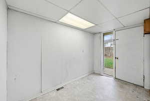 Spare room with tile patterned floors and a drop ceiling