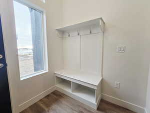 Mudroom with wood finished floors and baseboards