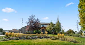 View of front of house featuring board and batten siding and a front lawn