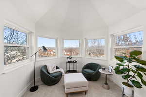 Sunroom / solarium featuring healthy amount of natural light and lofted ceiling