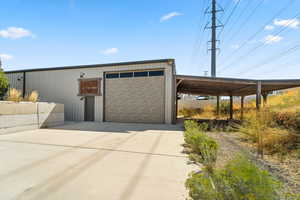 Garage with a carport and concrete driveway