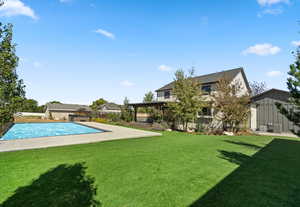 Outdoor pool with a yard, a pergola, and a patio area
