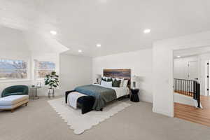 Bedroom with light carpet and recessed lighting