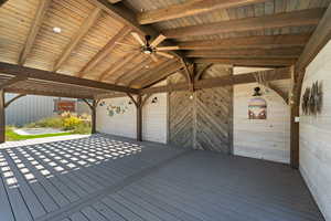 Wooden deck featuring a ceiling fan