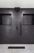 Full bath featuring tiled shower