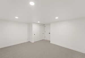 Finished basement featuring recessed lighting and carpet