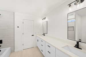 Full bath featuring double vanity and shower / washtub combination